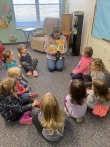 PreK kids reading in a circle